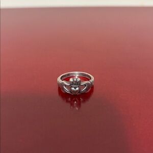 Claddagh style silver Hand holding heart ring crown hands